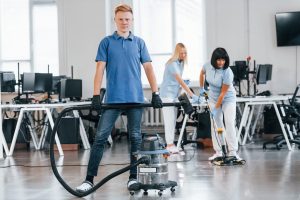 A group of cleaners from a soft cleaning company cleans the office.